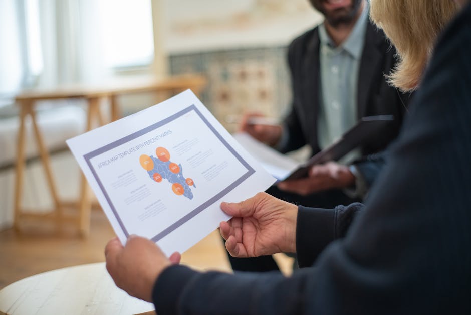 Three professionals discussing a data presentation in an office setting.